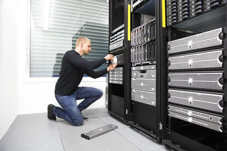 A man performing Managed IT on a server in a data center.