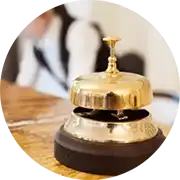 A golden bell sits on top of a wooden table.
