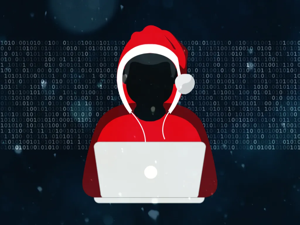 A person wearing a santa hat is sitting on a laptop, enjoying the holidays.