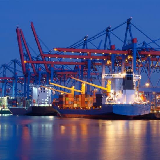 A ship docks in a harbor, securing American ports from cyber threats.