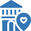 Icon of a building with a rounded roof next to a location pin containing a heart symbol, all in blue, symbolizing the supportive role of nonprofit IT in connecting communities.