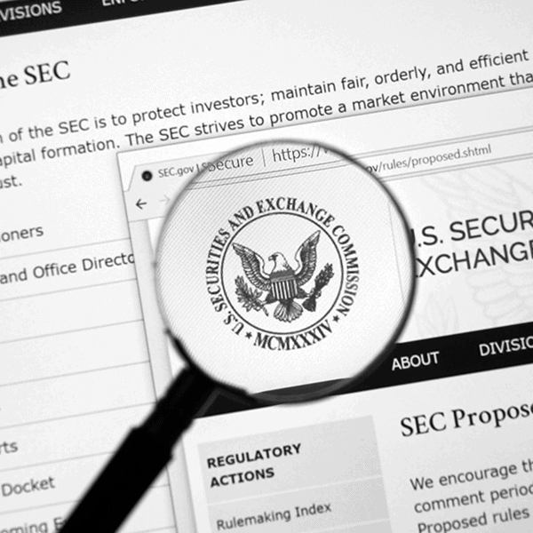 A magnifying glass focuses on the U.S. Securities and Exchange Commission's seal on a webpage, highlighting upcoming 2024 cybersecurity disclosure compliance requirements.