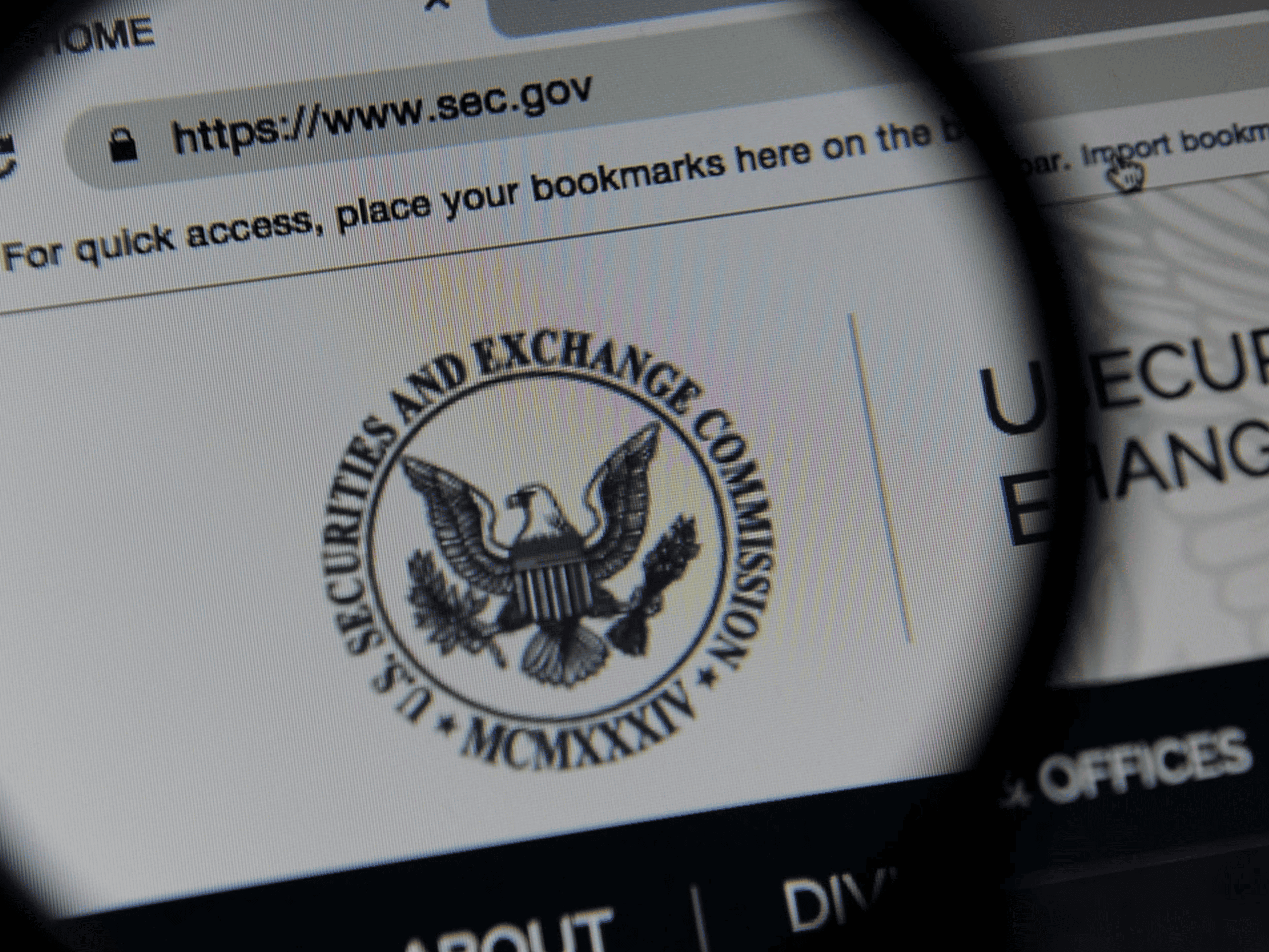 Close-up of a web page featuring the U.S. Securities and Exchange Commission logo under a magnifying glass, highlighting the new 2024 cybersecurity disclosure compliance standards.