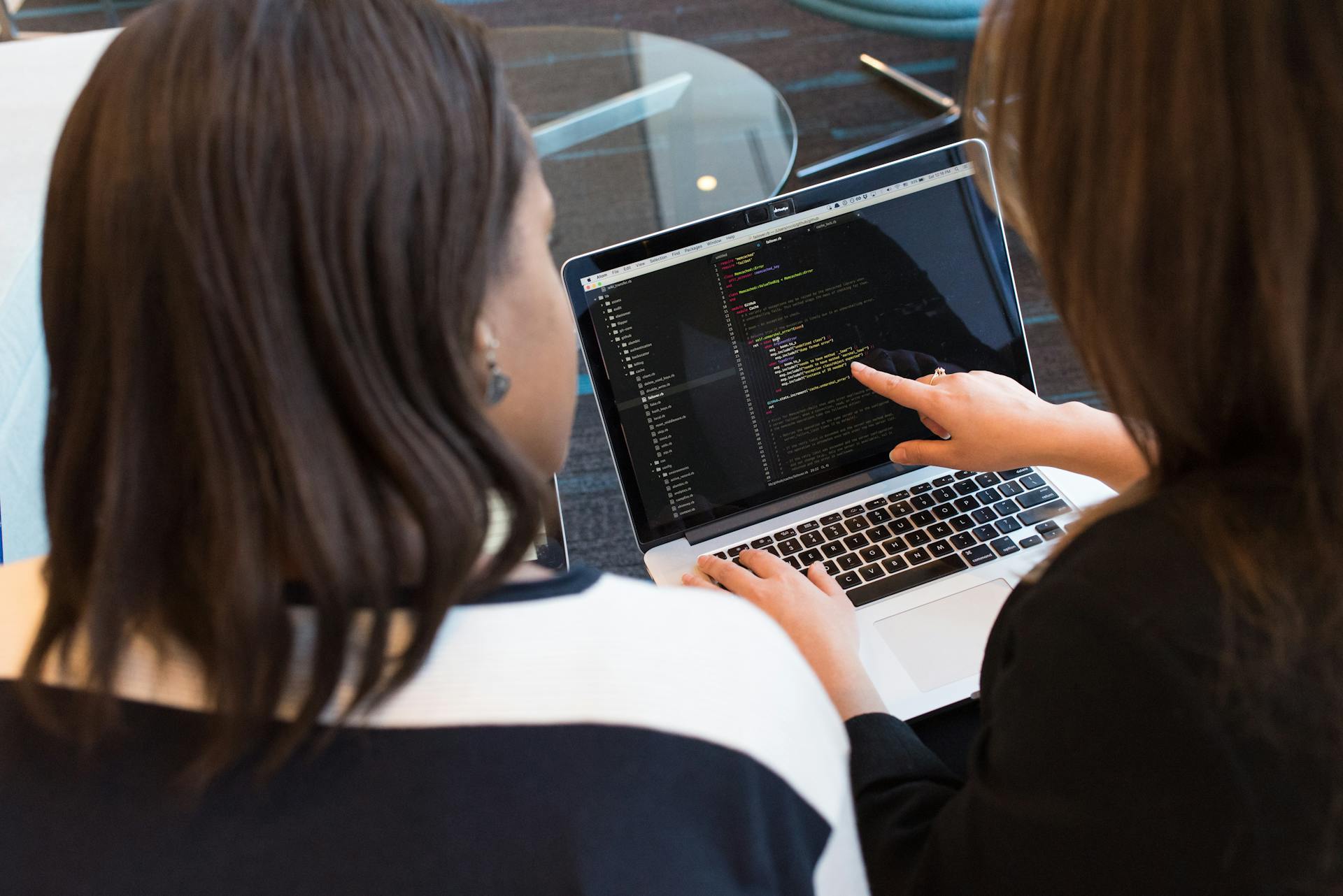 Cybersecurity analyst monitoring multiple screens for Massachusetts business threat detection — Triton Technologies.