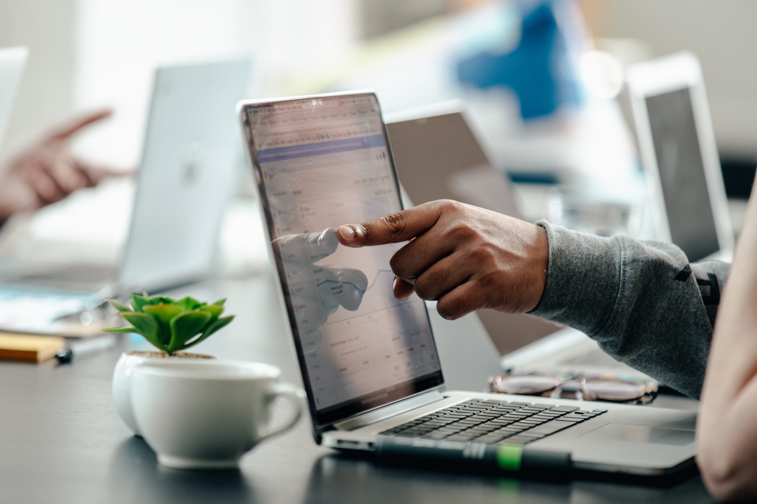 IT consultant reviewing analytics on laptop — project-based IT outsourcing and planning