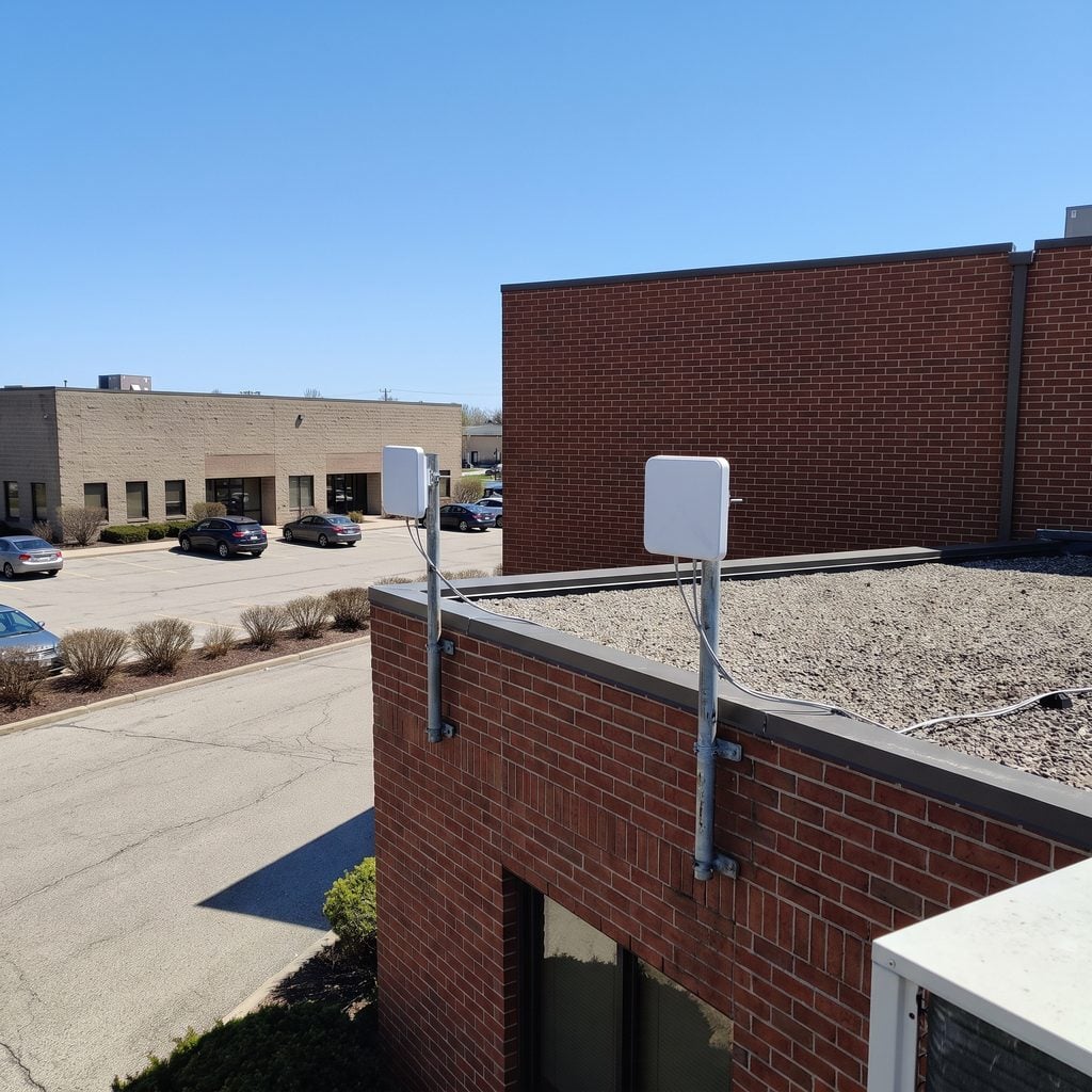 Point-to-point wireless antennas on a rooftop linking two commercial buildings