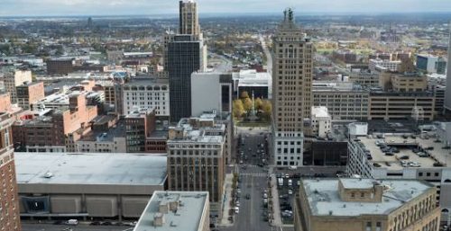 An aerial view of a downtown cityscape, with a mix of modern and historic buildings, managed IT services Buffalo under a cloudy sky.