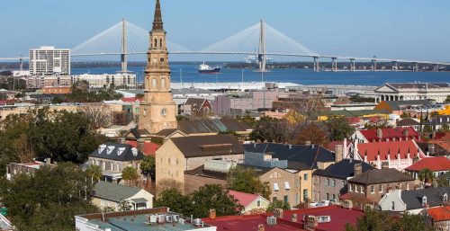 Charleston, South Carolina skyline featuring the historic church steeple and the Arthur Ravenel Jr. Bridge in the background, a city known for its managed IT services.