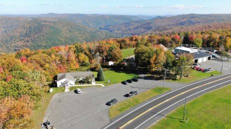 An aerial view of a road winding through the mountains. An aerial view of a road winding through the mountains.