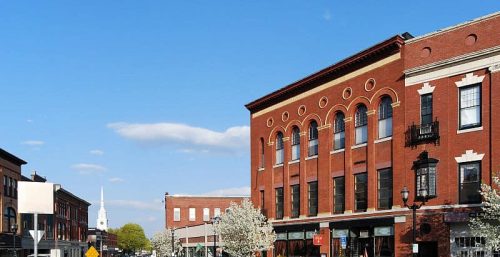A red brick building on the corner of a street offers managed IT services in Hudson.