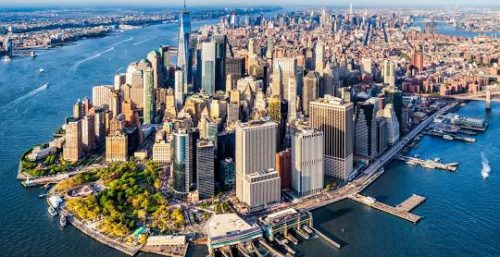 Aerial view of lower Manhattan, showcasing managed IT services in New York City, including the Brooklyn Bridge and One World Trade Center.