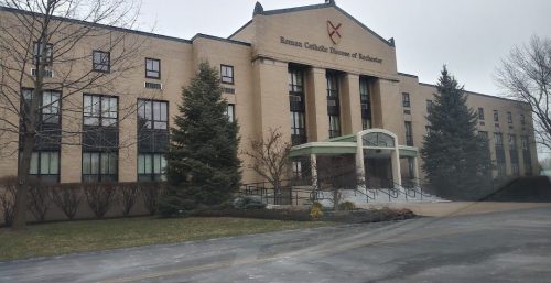 Exterior view of a modern educational building with a cross symbol, indicating a religious affiliation, possibly a catholic institution, and managed IT services in Ogden.