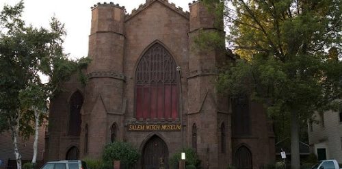 A brick building with a car parked in front of it in Salem.
