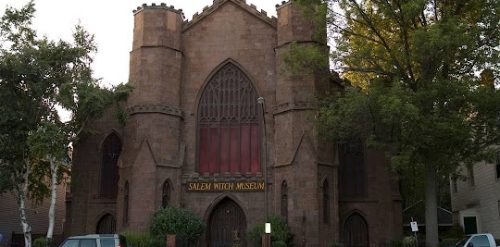 A brick building with a car parked in front of it in Salem.