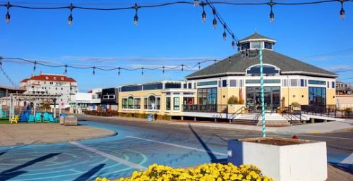 Boardwalk pavilion with string lights under a clear blue sky, featuring managed IT service Salisbury.
