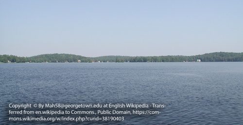 A wide, calm lake with a forested treeline in the distance under a clear sky evokes tranquility, much like the seamless support of managed IT services in Stratford. (Photo by Mah58/CC BY-SA 3.0 via Wikimedia Commons).