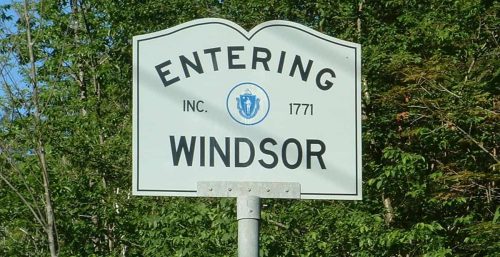 Town welcome sign reading "entering Windsor, Managed IT Service Inc. 1771" with a coat of arms and trees in the background.