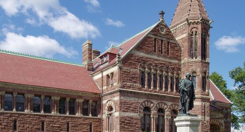A large brick building with a statue in front of it is located in Woburn.